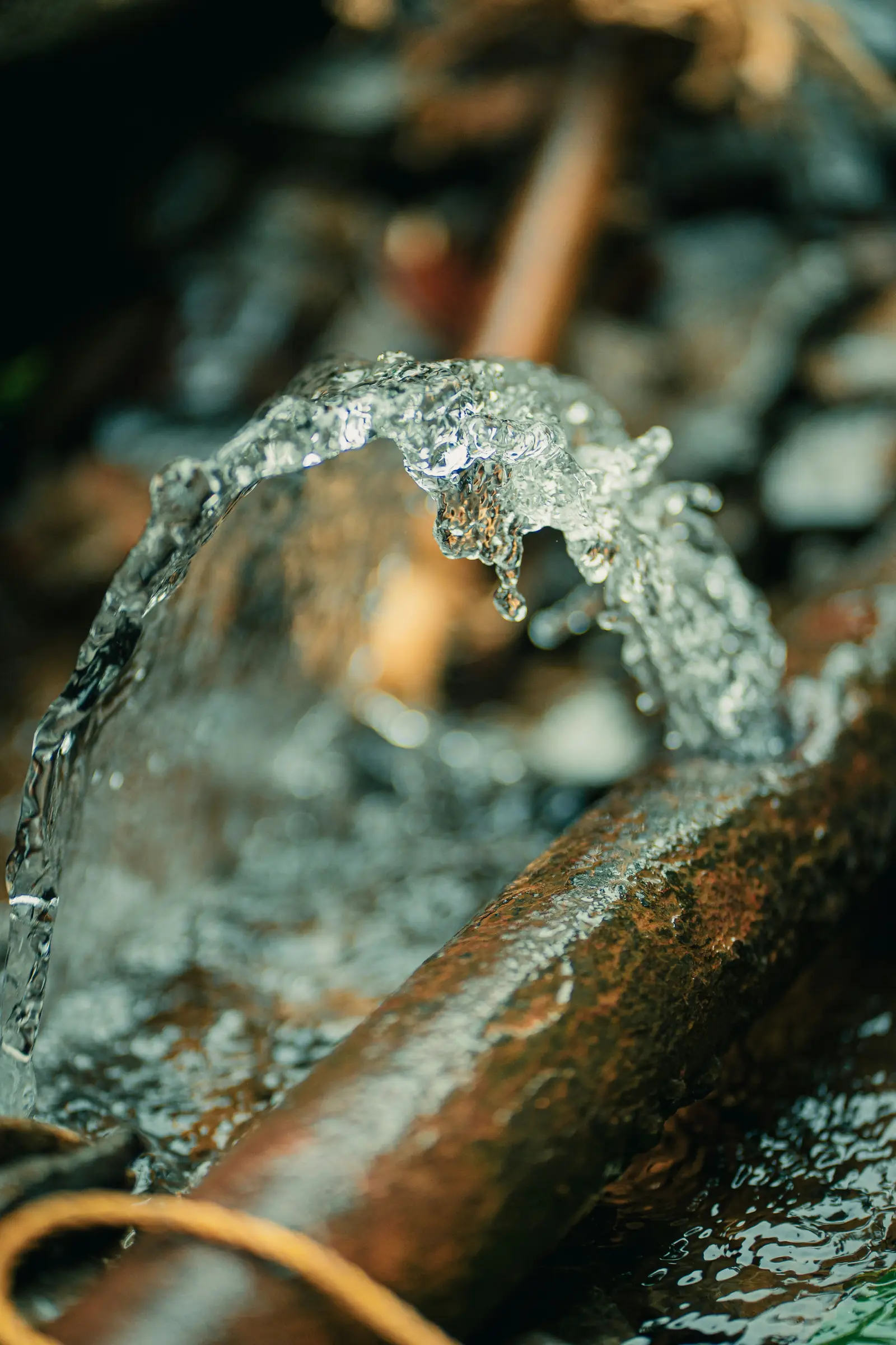 Water rushing over aged copper pipe
